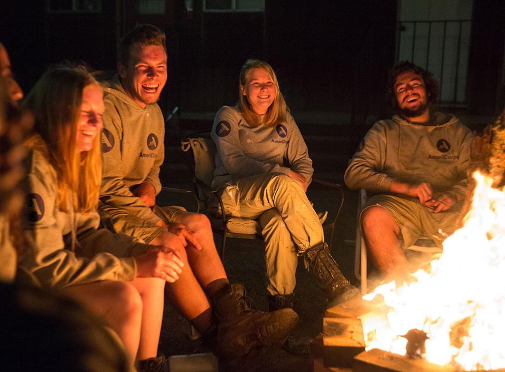 Group of people sitting around a fire