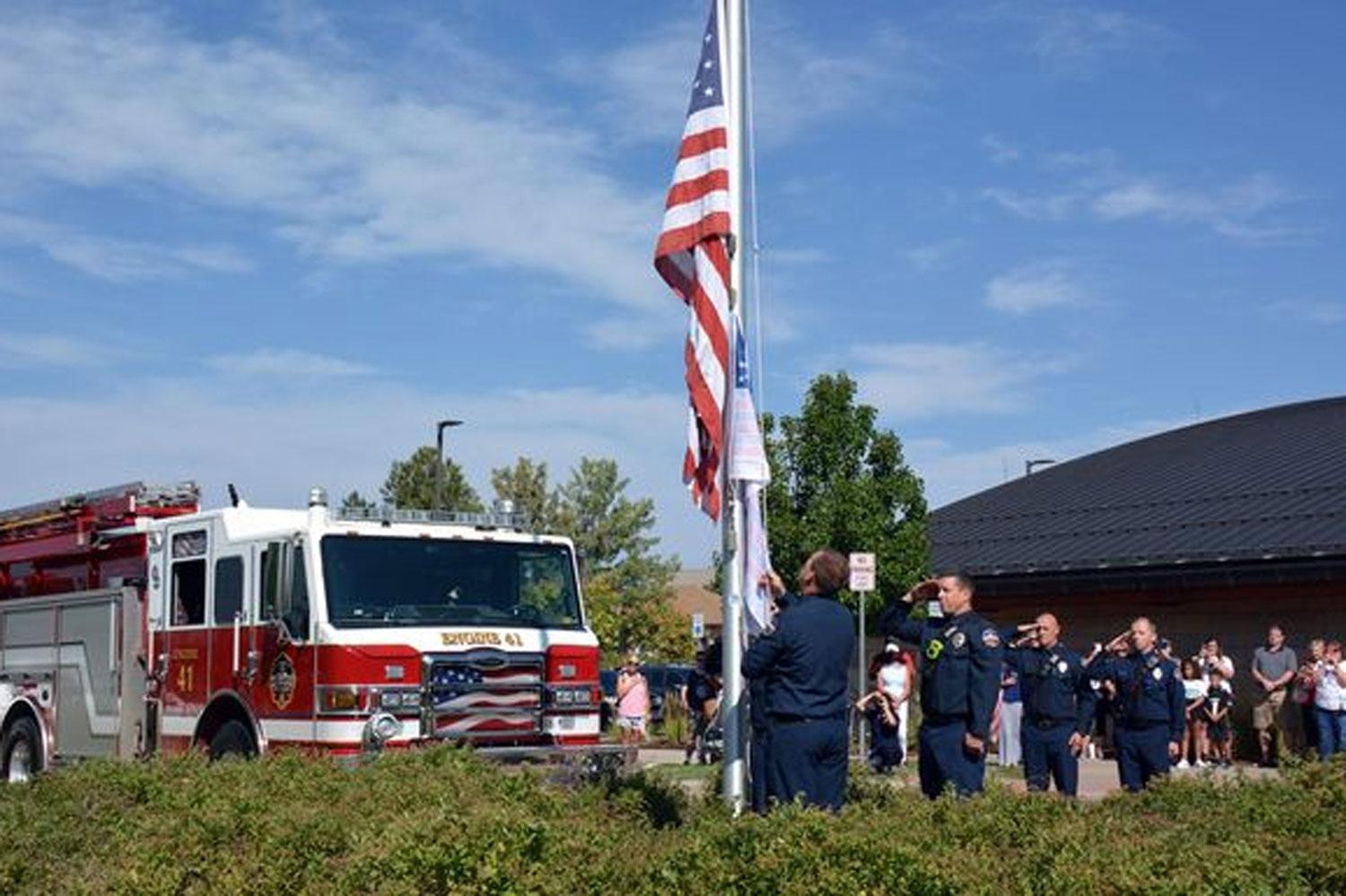 Firefighters raising the flag at the first annual 9/11 Day Flag of Honor Across America Memorial