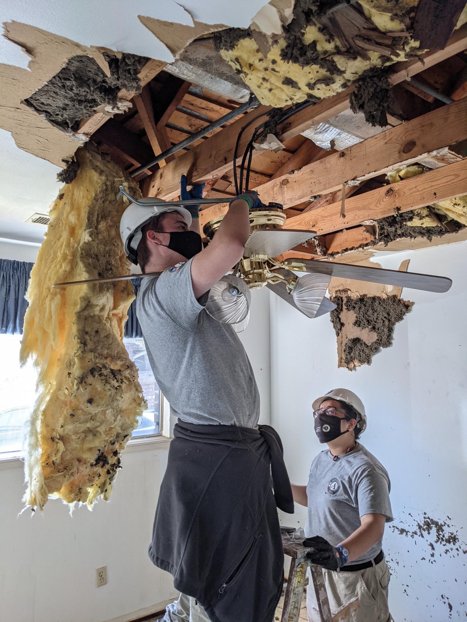 NCCC members remove waterlogged insulation from Houston home. 