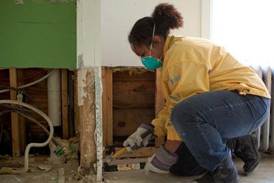 An AmeriCorps member working to restore a community affected by a hurricane