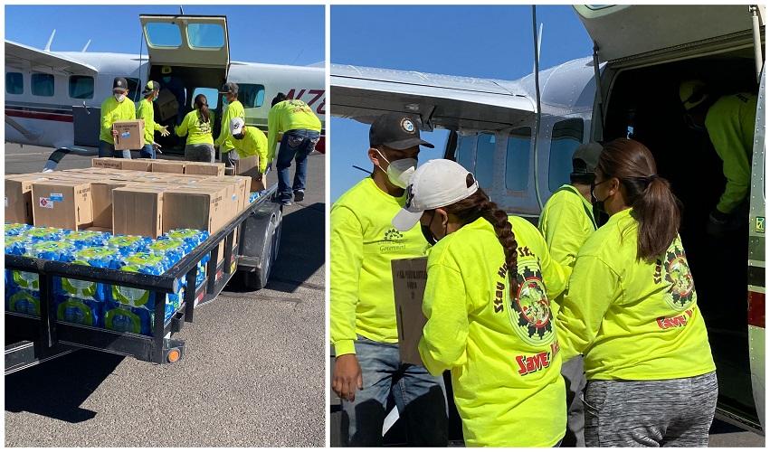 Chinle Chapter members load water into plane to dispense to community