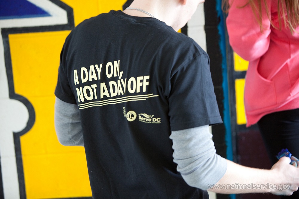 T-shirt of a volunteer with MLK Day tagline "Make it a day on, not a day off!"