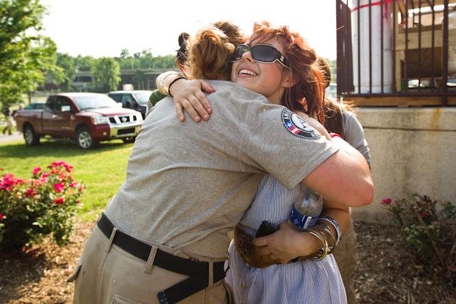 An AmeriCorps member hugs a community resident