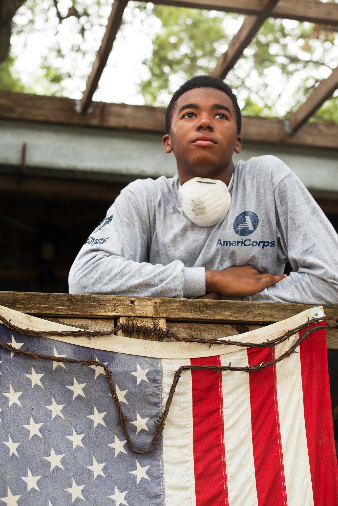 AmeriCorps member with American flag 